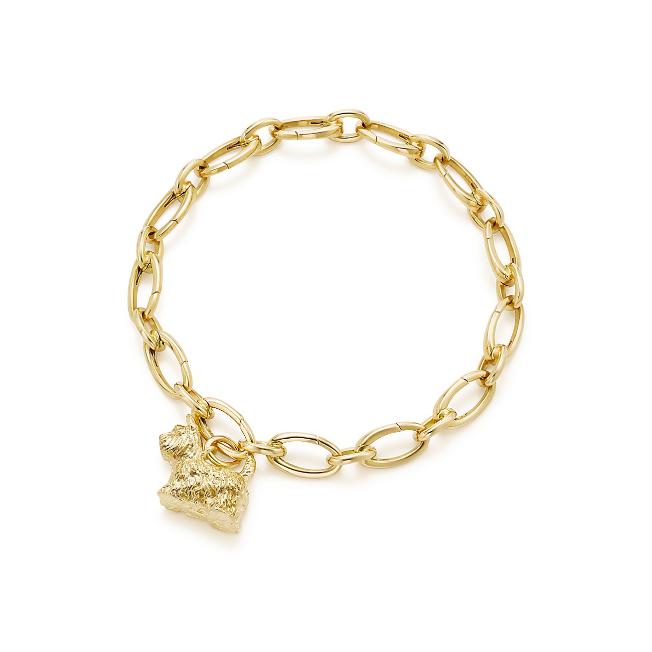 Dog charm in 18k gold on a link clasp bracelet. Tiffany & Co.