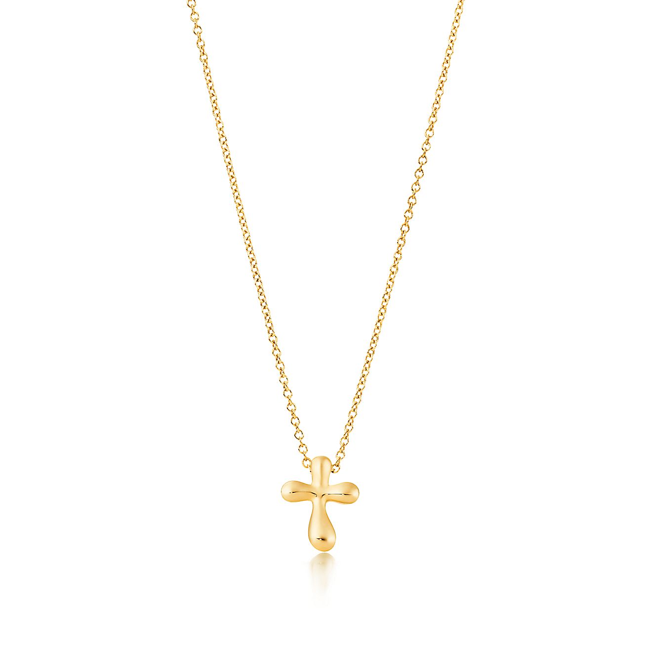 Elsa Peretti® cross pendant in 18k gold, 12 mm wide. Tiffany & Co.
