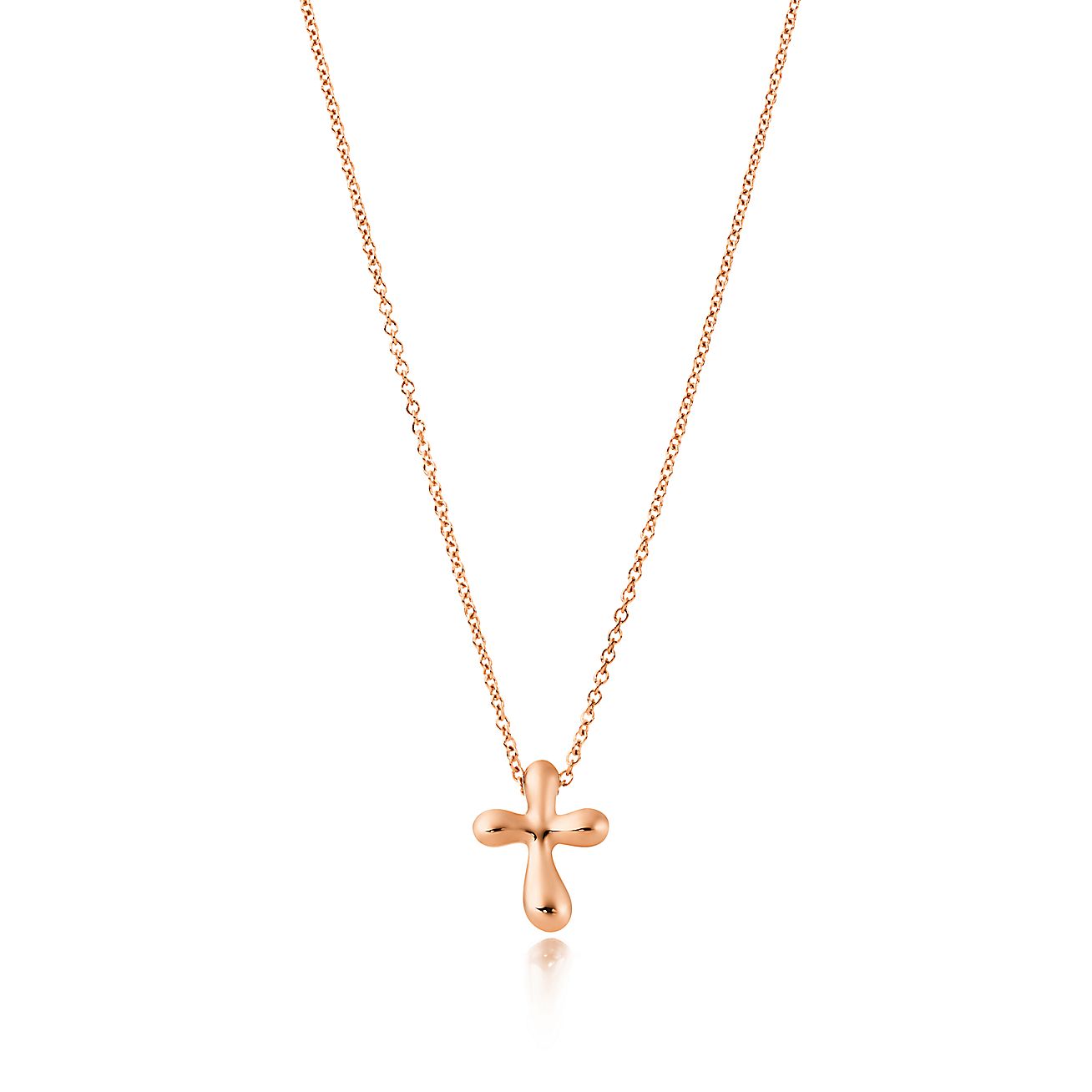 Elsa Peretti® cross pendant in 18k rose gold, 12 mm wide. Tiffany & Co.