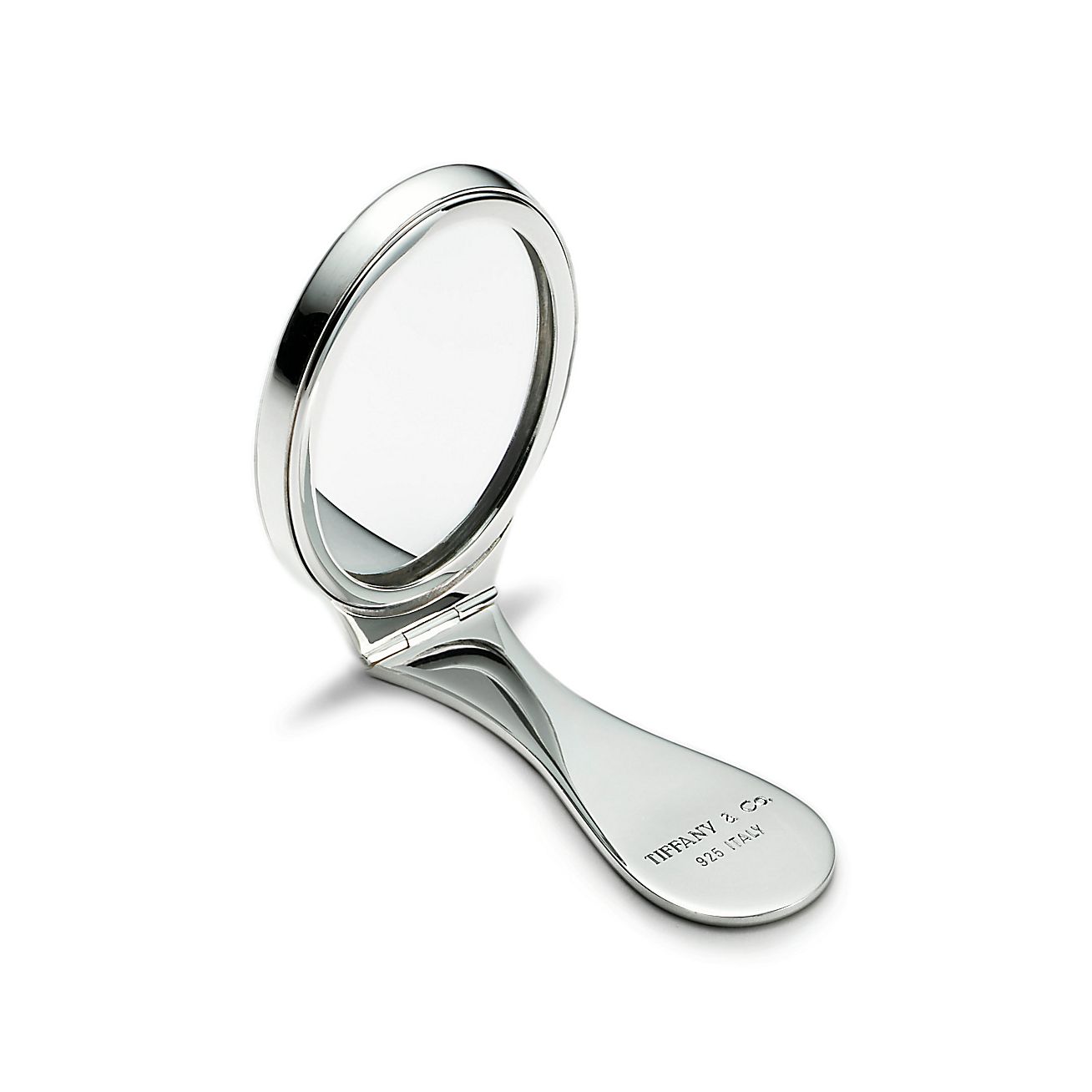 Purse mirror in sterling silver with folding handle. Tiffany & Co.