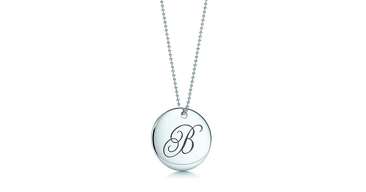 Tiffany Notes letter round pendant in sterling silver. Letters AZ