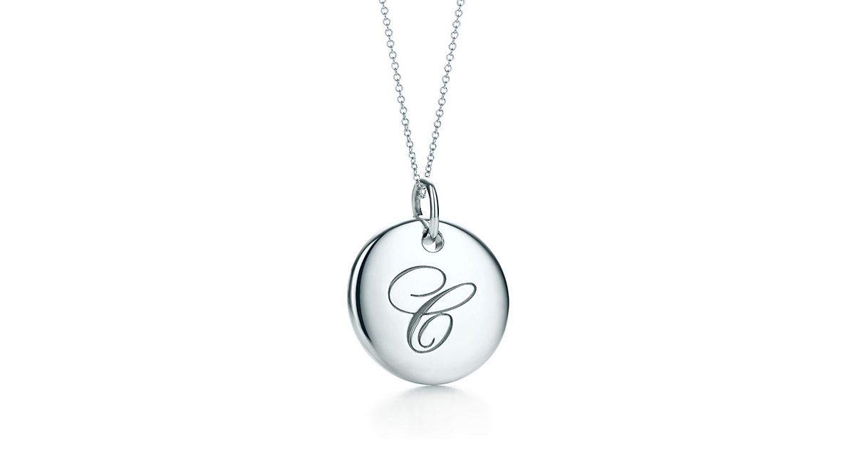 Tiffany Notes alphabet disc charm in silver on a chain. Letters AZ