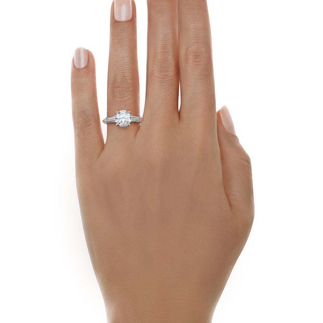 Round cut diamond ring with tapered baguettes