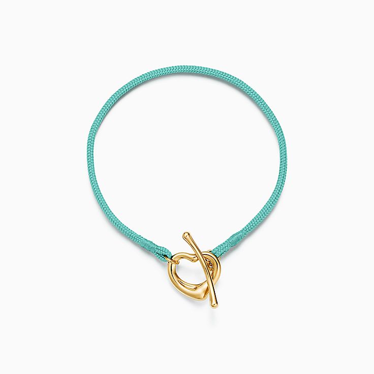 Elsa Peretti® Open Heart Bracelet in Yellow Gold on a Tiffany Blue