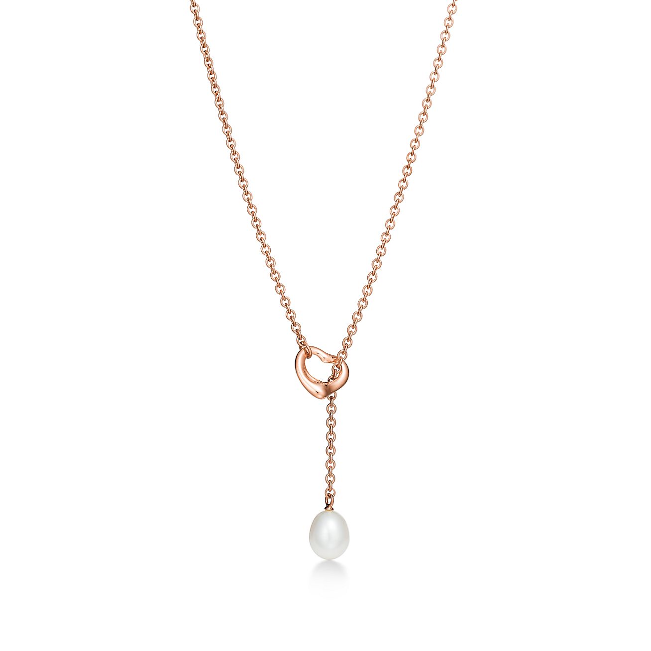 Elsa Peretti® Open Heart lariat in 18k rose gold with a freshwater pearl.