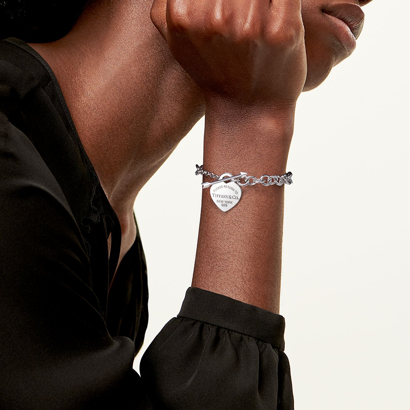 Return to Tiffany™ heart tag charm in sterling silver on a bracelet. |  Tiffany & Co.