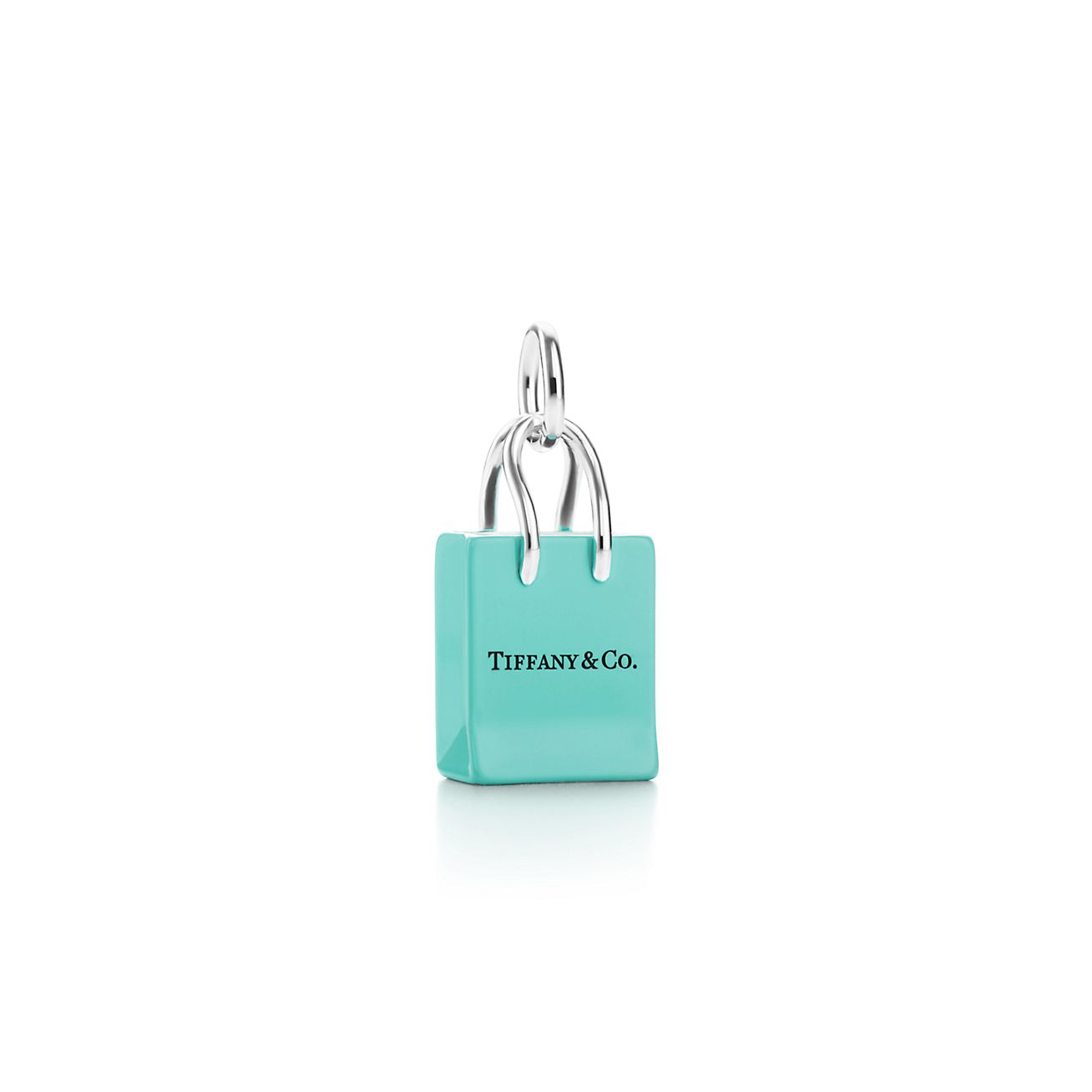 Tiffany & Co.® shopping bag charm in sterling silver with enamel finish.