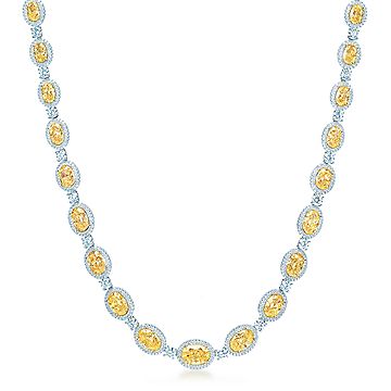 Oval Fancy Intense Yellow diamond necklace in platinum with white