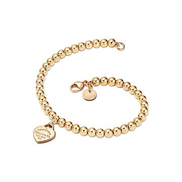 Return to Tiffany mini heart tag on a bead bracelet in 18k gold