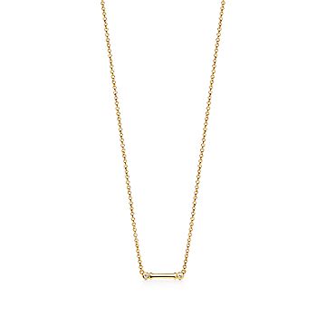 Tiffany Fleur de Lis key bar pendant in 18k gold with diamonds