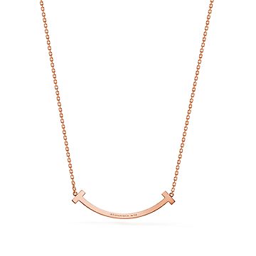 Tiffany T medium smile pendant in 18k gold with diamonds.