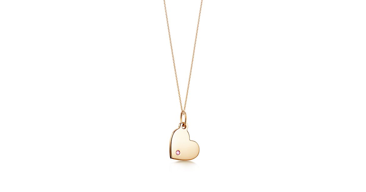 Tiffany Charms heart tag in 18k gold with a pink sapphire, mini. Tiffany & Co.