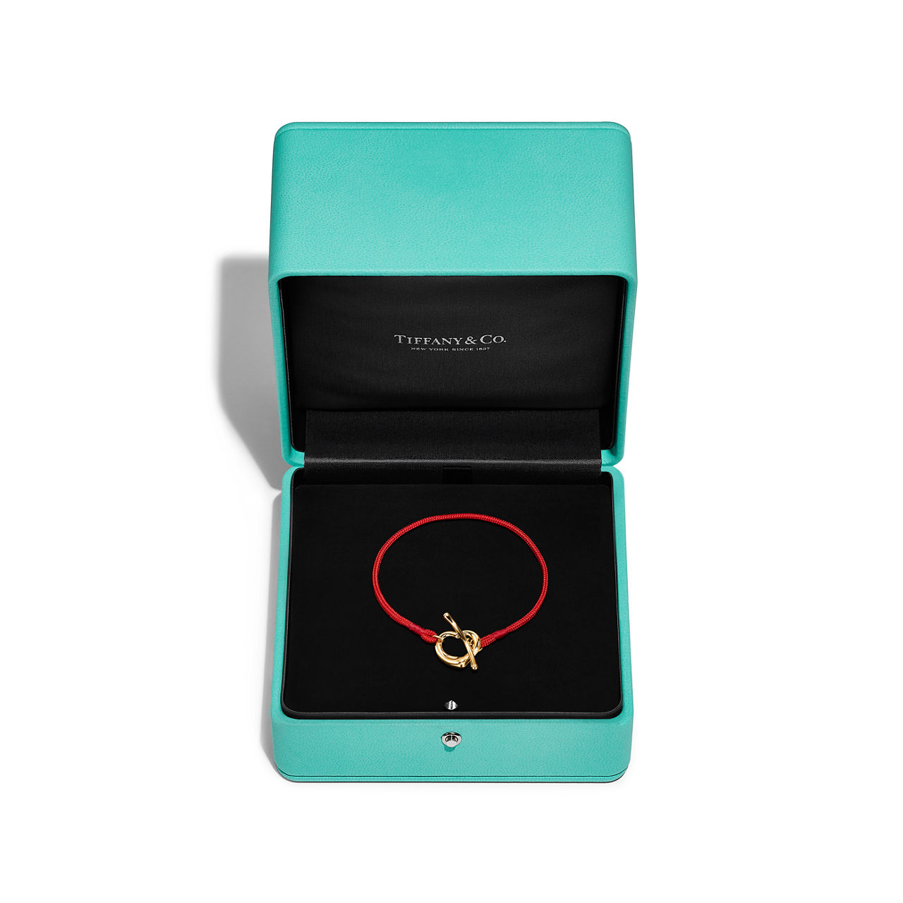 Elsa Peretti®:Open Heart Bracelet in Yellow Gold on a Red Silk