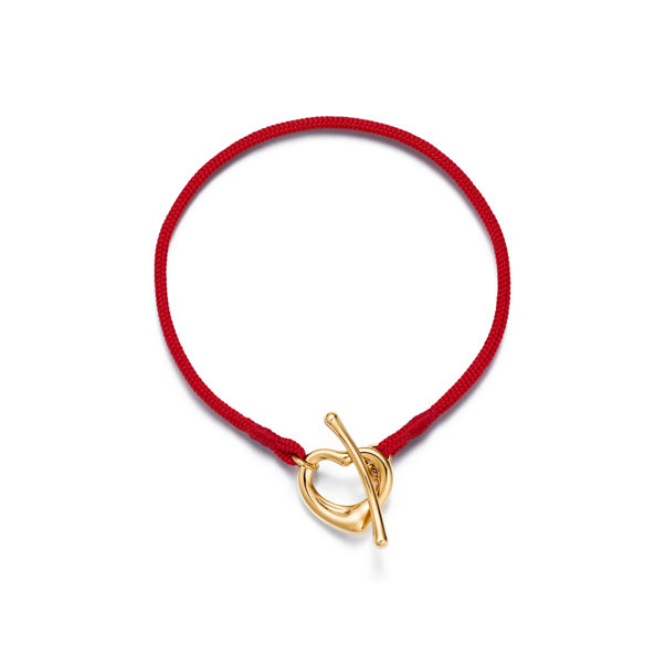 Elsa Peretti®:Open Heart Bracelet in Yellow Gold on a Red Silk Cord