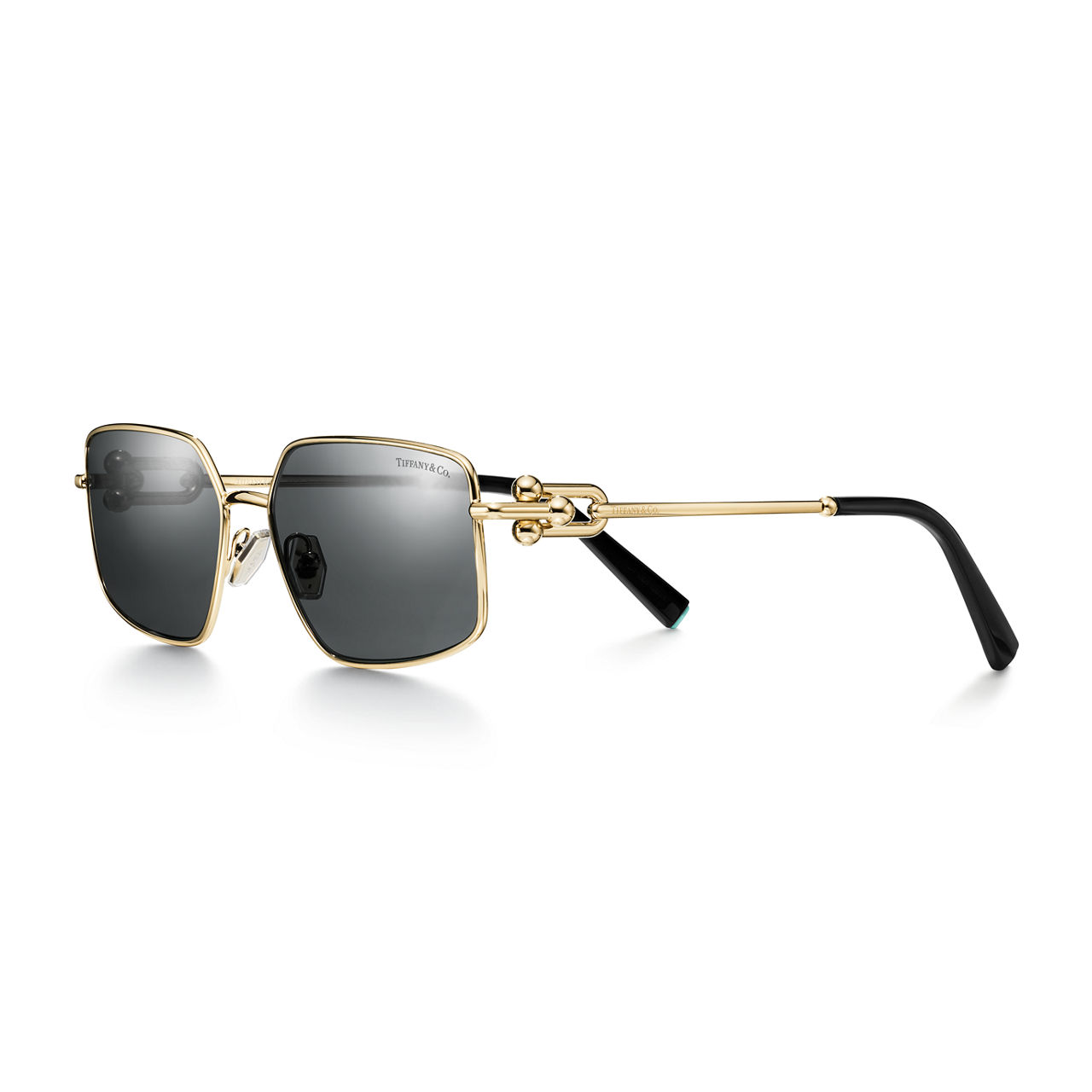 Sonnenbrille aus blassgoldenem Metall mit dunkelgrauen Gläsern