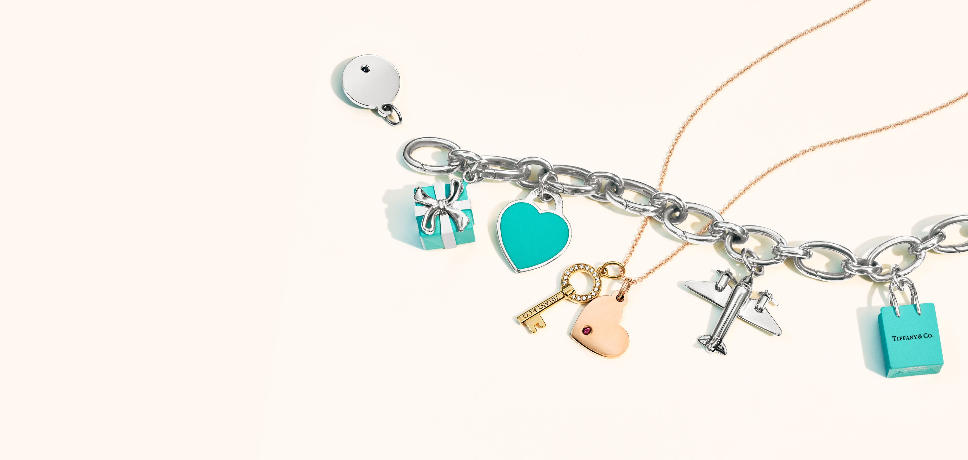 Tiffany & Co.® shopping bag charm in sterling silver with enamel finish.